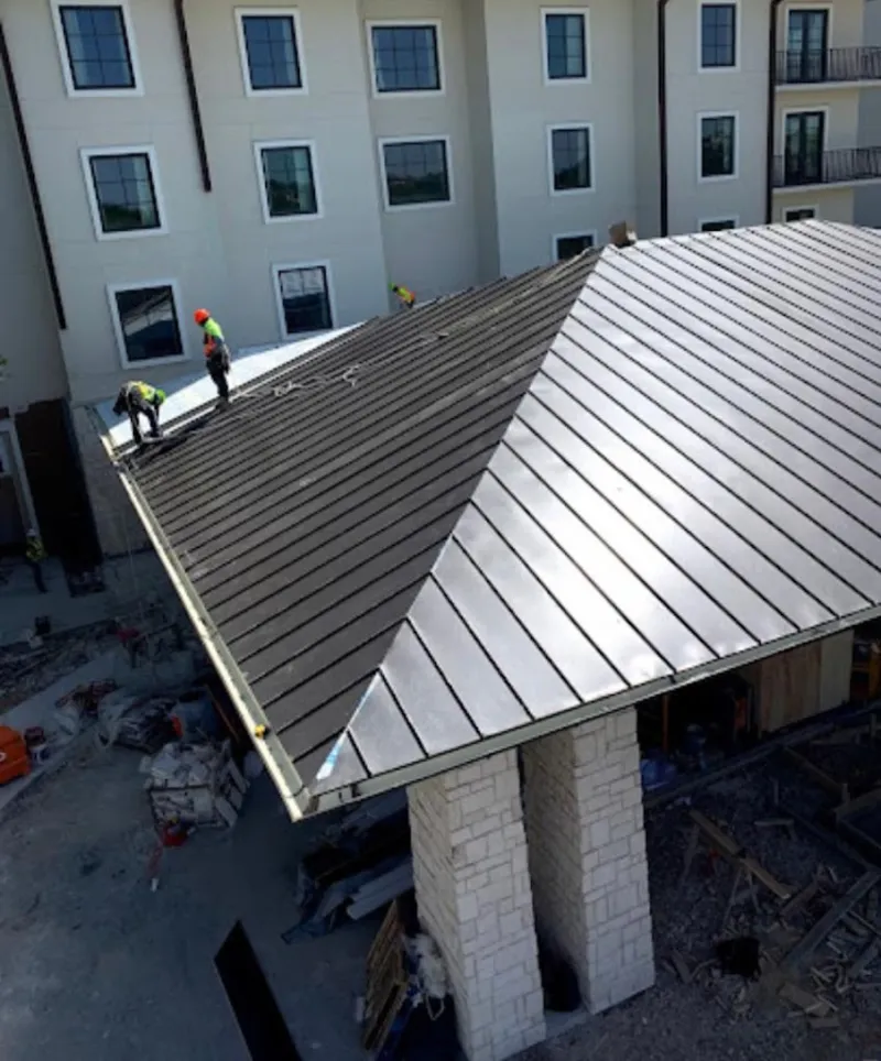 Crew installing standing seam metal roof panels on a commercial project in Lynnwood